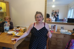 Woman in Polka Dot Dress at Home Gathering