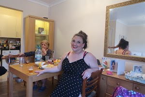 Woman at Dining Table During Home Gathering