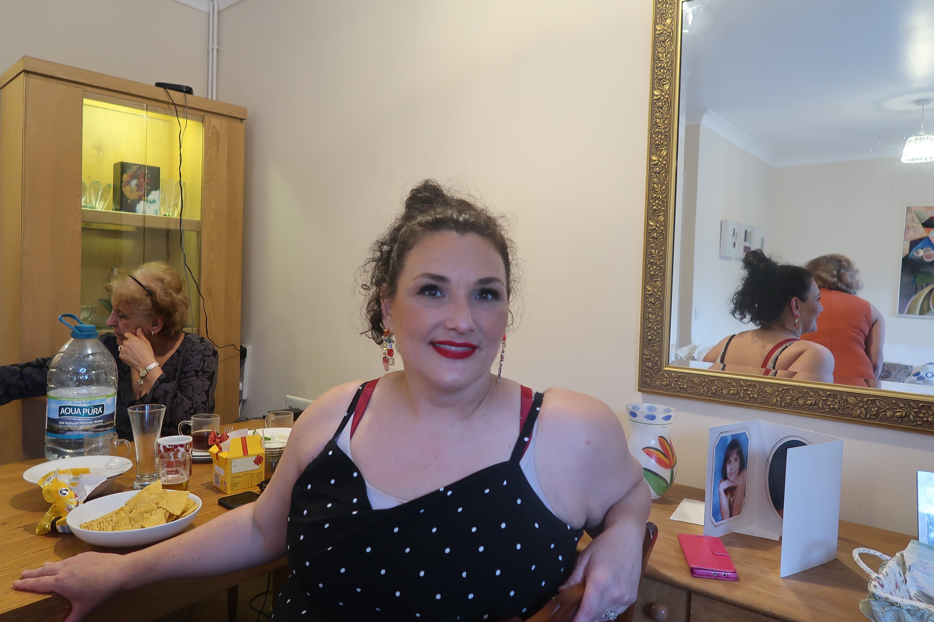 Woman in Polka Dot Dress at Dining Table