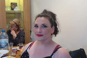 Woman with Red Lipstick at Indoor Gathering
