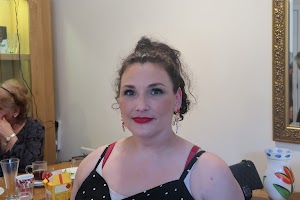 Woman in Polka-Dot Dress at Indoor Gathering