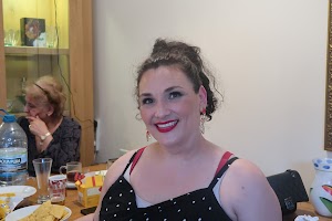 Smiling Woman at Indoor Gathering