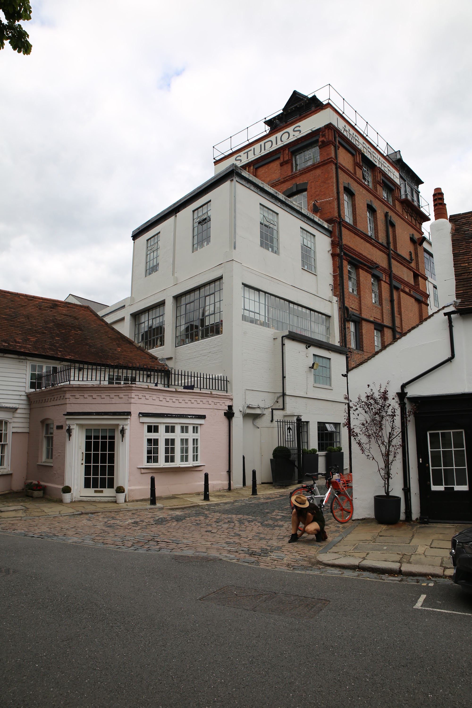 Street View of Studios Building with Pink Annex and Cyclist