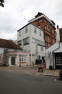 Street View of Studios Building with Pink Annex and Cyclist