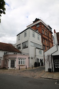 White and Red Brick Studios Building on Cobblestone Street