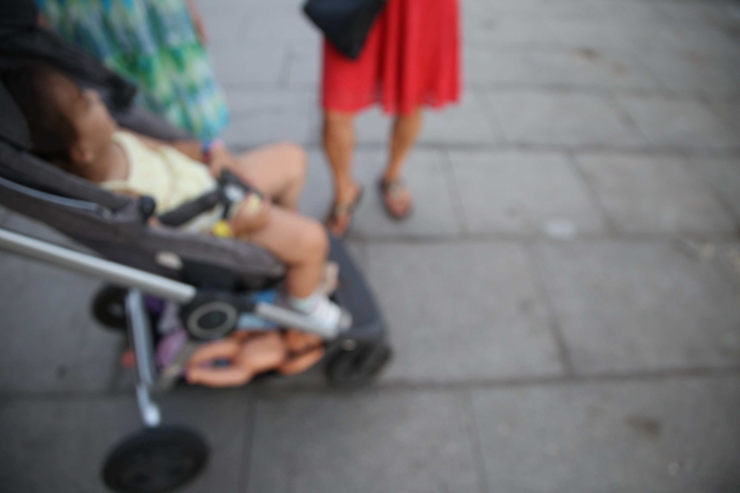 Child in Stroller on Sidewalk
