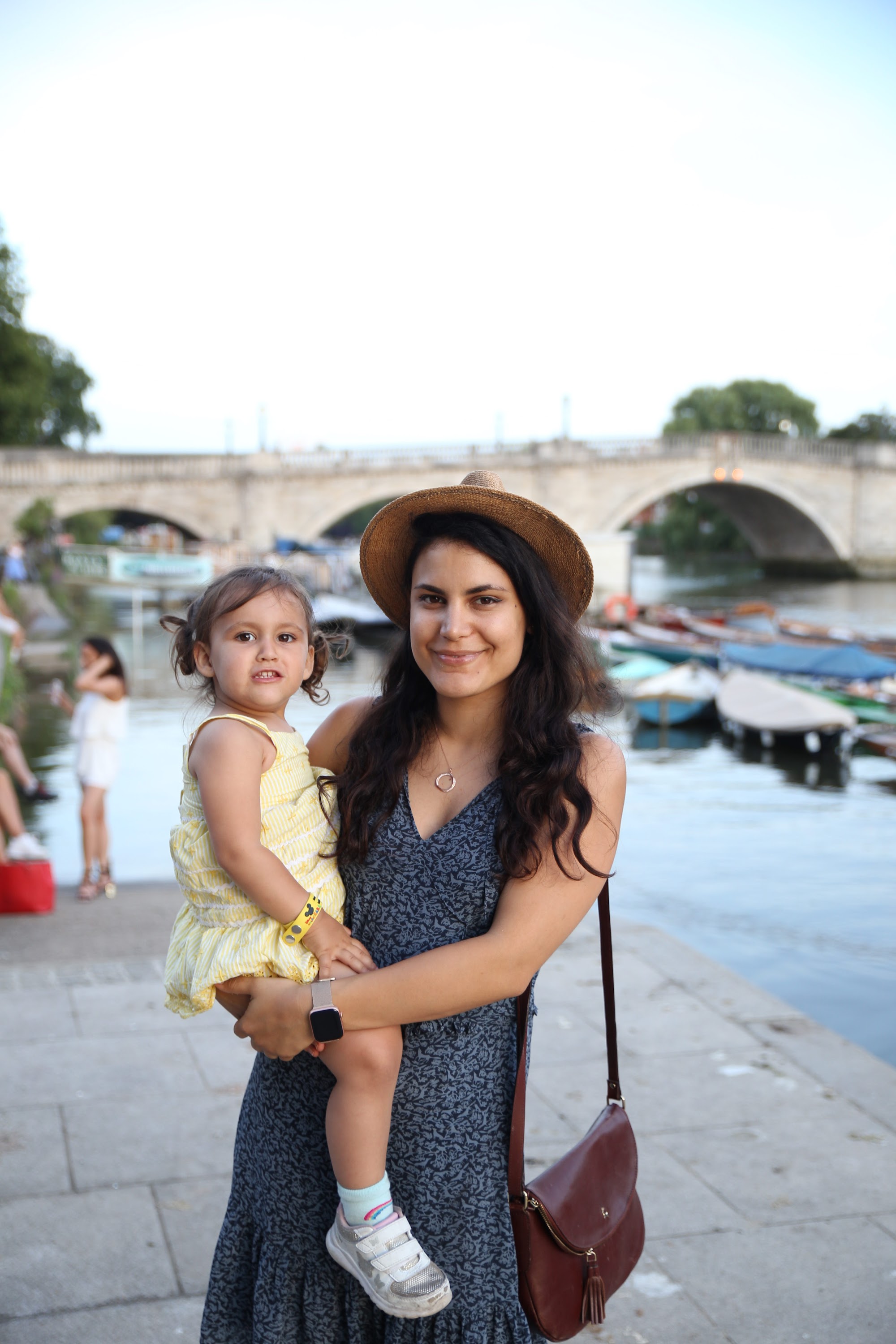 Mother Holding Daughter by Riverbank