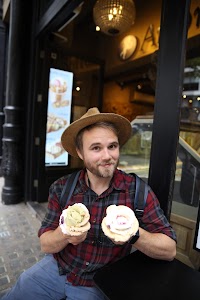 Man Enjoying Ice Cream Outside a Shop