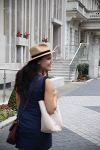Woman in Hat Walking Outside a Building