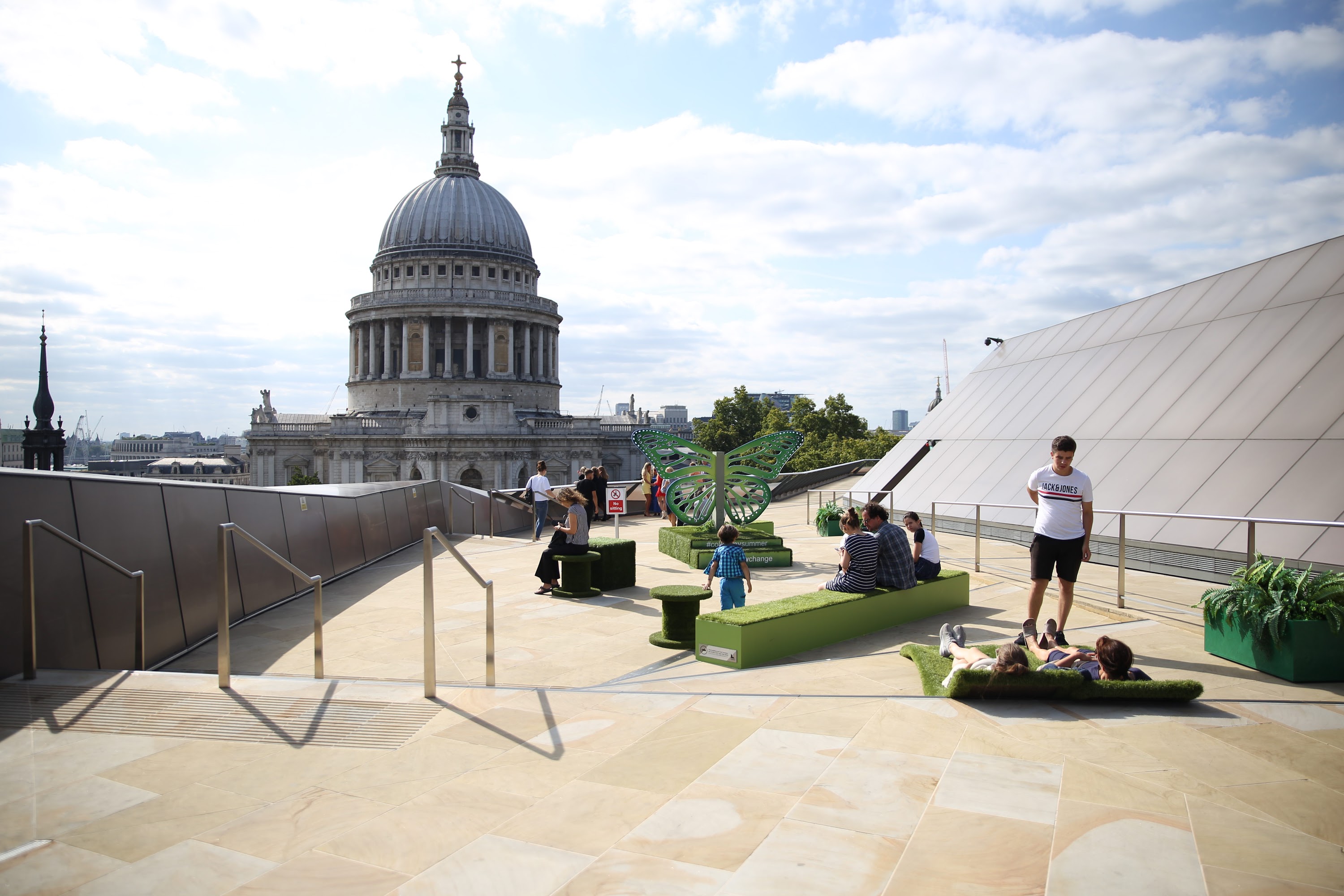 Visitors enjoying the rooftop terrace with St. Paul's Cathedral in the background
