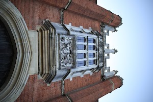Ornate Stone Relief and Gothic Window on Red Brick Building