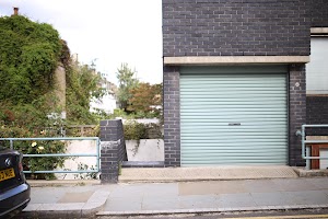 Green Garage Door on Brick Building
