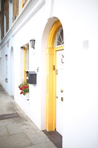 Yellow-Arched Doorway on White Townhouse