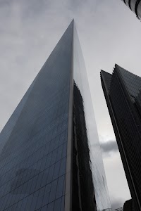The Shard skyscraper in London, viewed from below against a cloudy sky