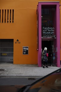Woman standing outside the Fashion and Textile Museum