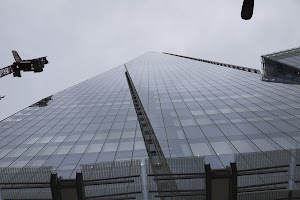 Low-angle view of The Shard skyscraper with construction crane