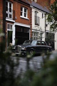 Black Bentley Continental Flying Spur parked on a residential street
