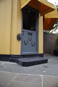 Horseshoe-Adorned Door with Horse Head Knocker