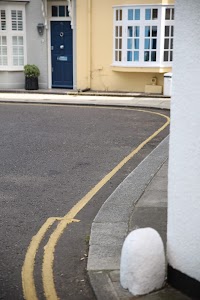 Curved Street with Yellow Lines and Residential Buildings