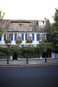 Blue House with Blue Shutters and Flower Boxes