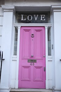 Pink Door with 'LOVE' Sign Above