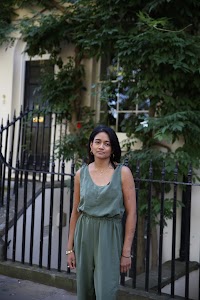 Woman in Olive Jumpsuit on Historic British Street