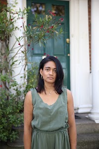Woman in Olive Jumpsuit on Historic British Street