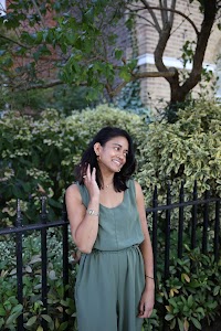 Woman in Olive Jumpsuit on Historic British Street