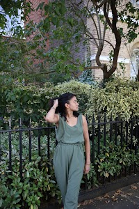 Woman in Olive Jumpsuit on Historic British Street