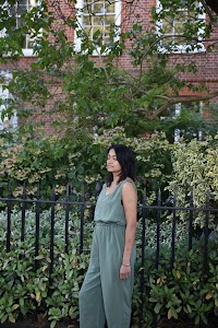 Woman in Olive Jumpsuit on Historic British Street