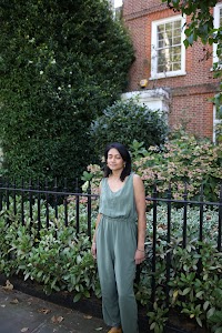 Woman in Olive Jumpsuit on Historic British Street