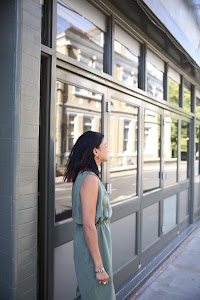 Woman in Olive Jumpsuit on Historic British Street