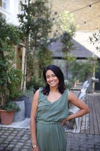 Woman in Olive Jumpsuit on Historic British Street