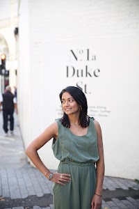 Woman in Olive Jumpsuit on Historic British Street