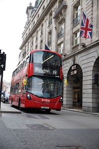 Red Double-Decker Bus Outside Ritz Club in London