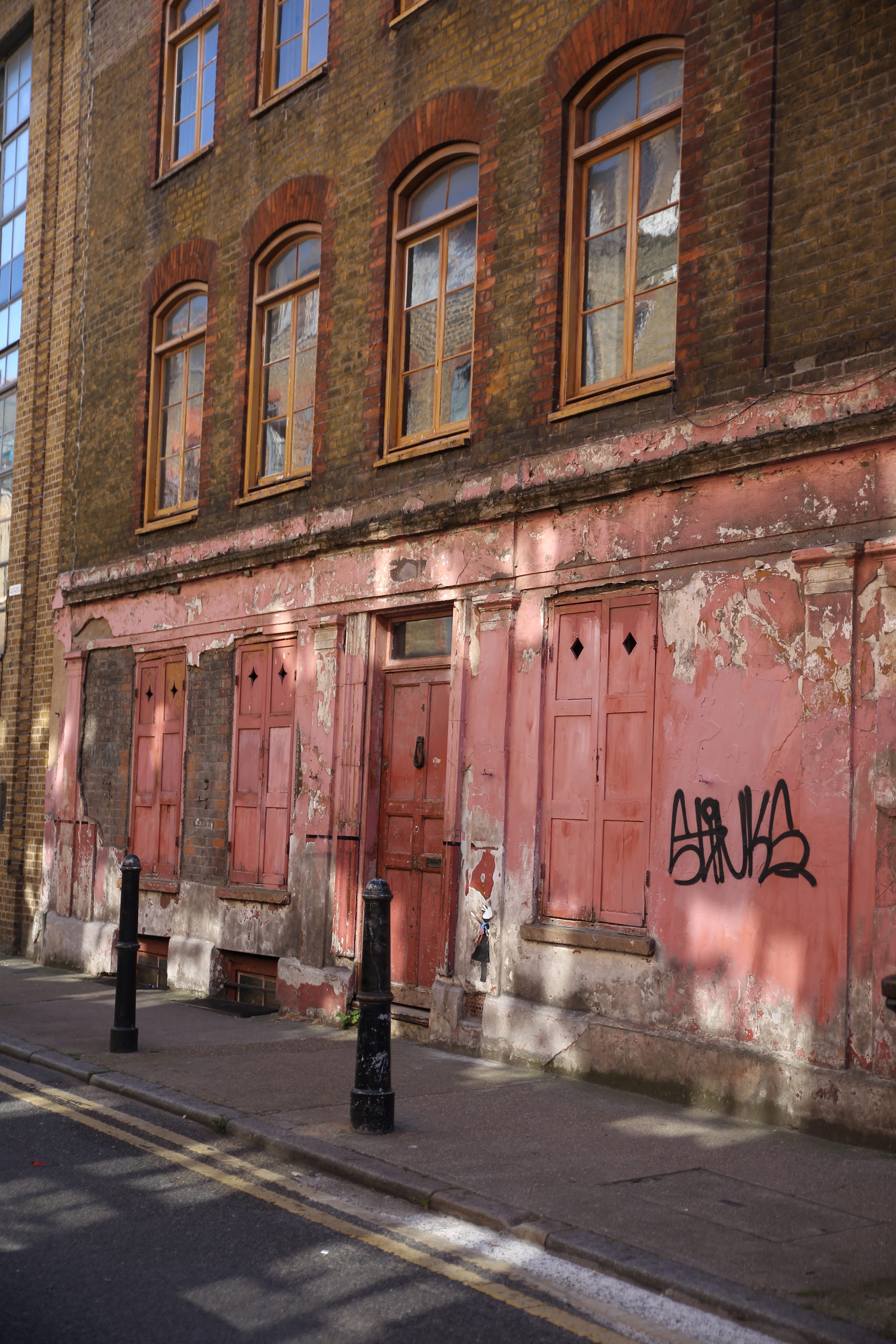 Weathered Red-Facade Building with Graffiti