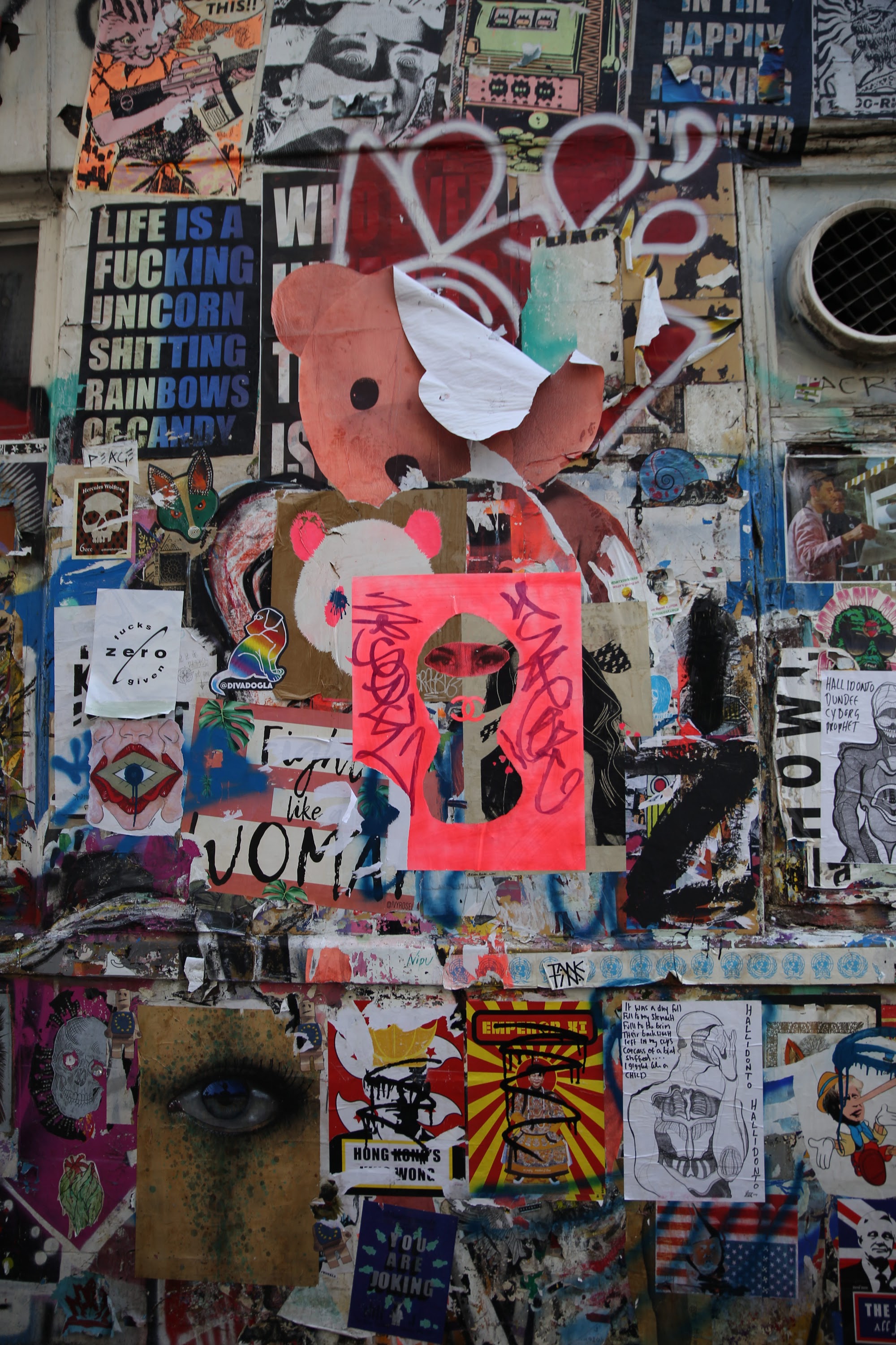 Street Wall Covered in Graffiti and Stickers