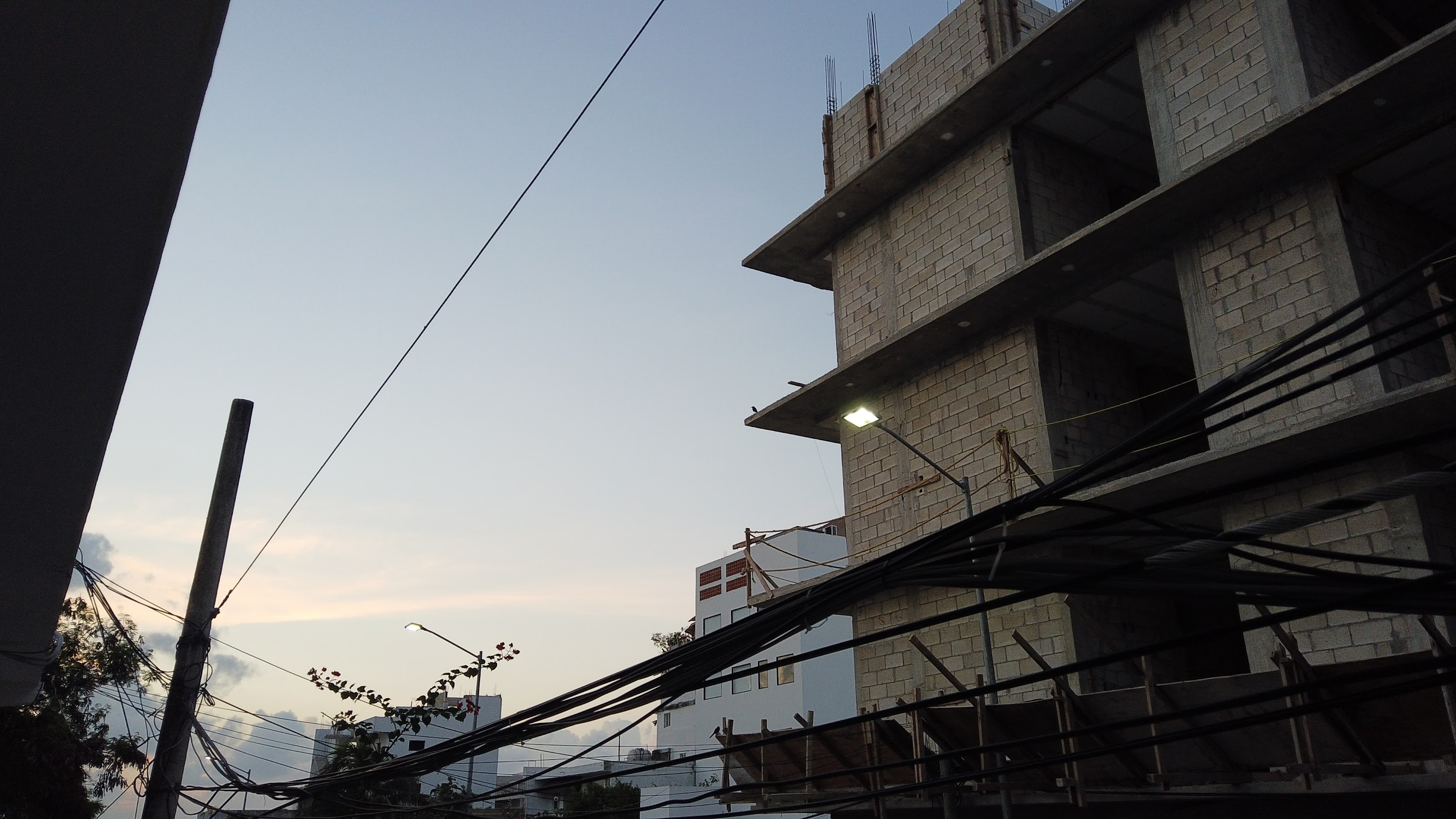 Multi-Story Concrete Building Under Construction at Dusk