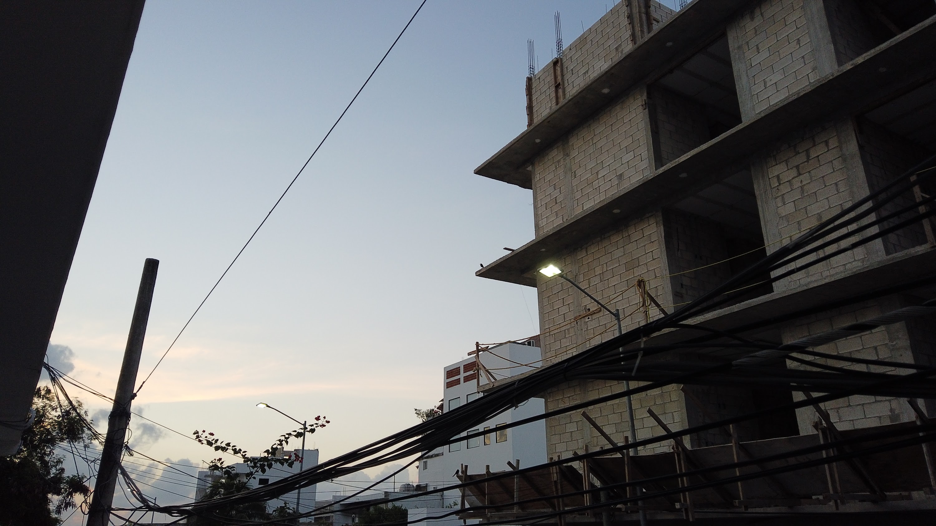Multi-Story Concrete Building Under Construction at Dusk