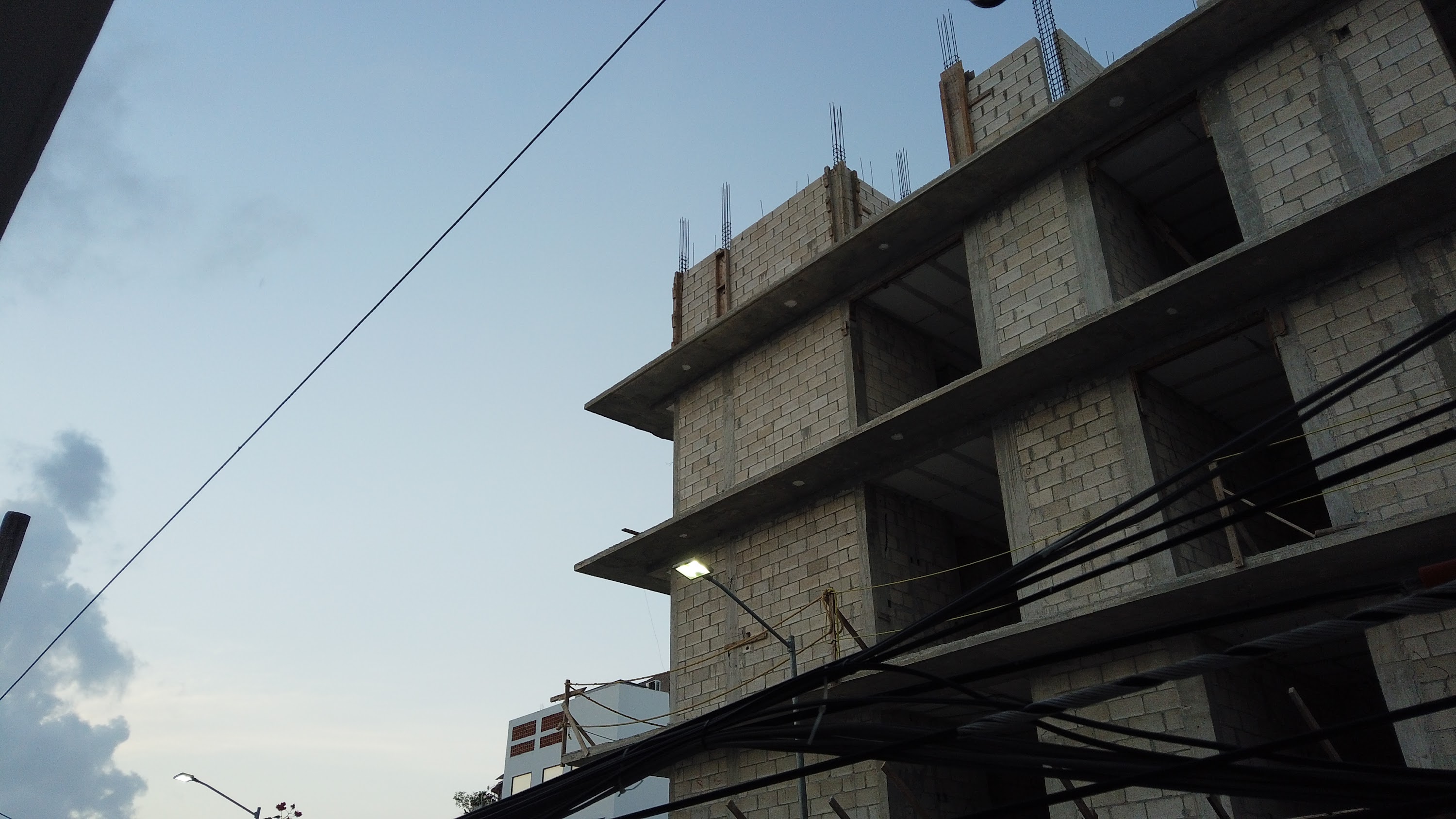 Multi-Story Concrete Building Under Construction at Dusk