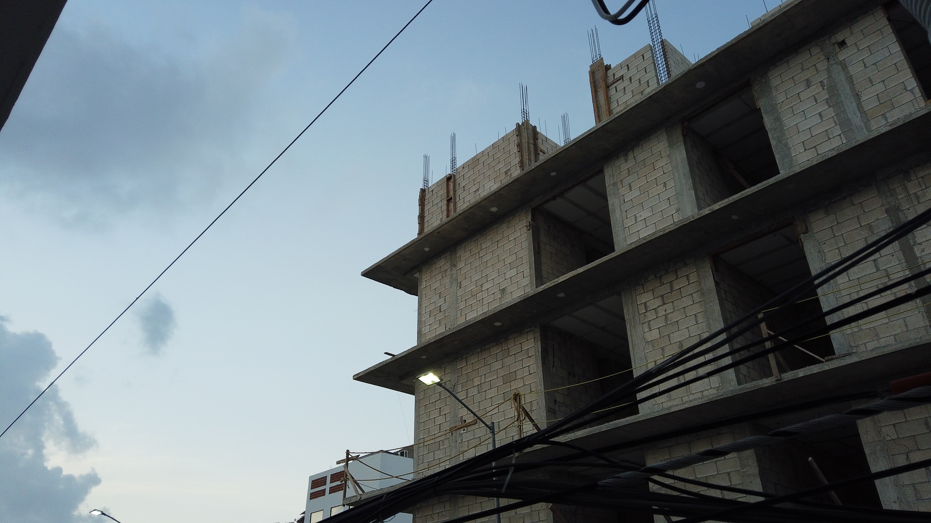 Multi-Story Concrete Building Under Construction at Dusk