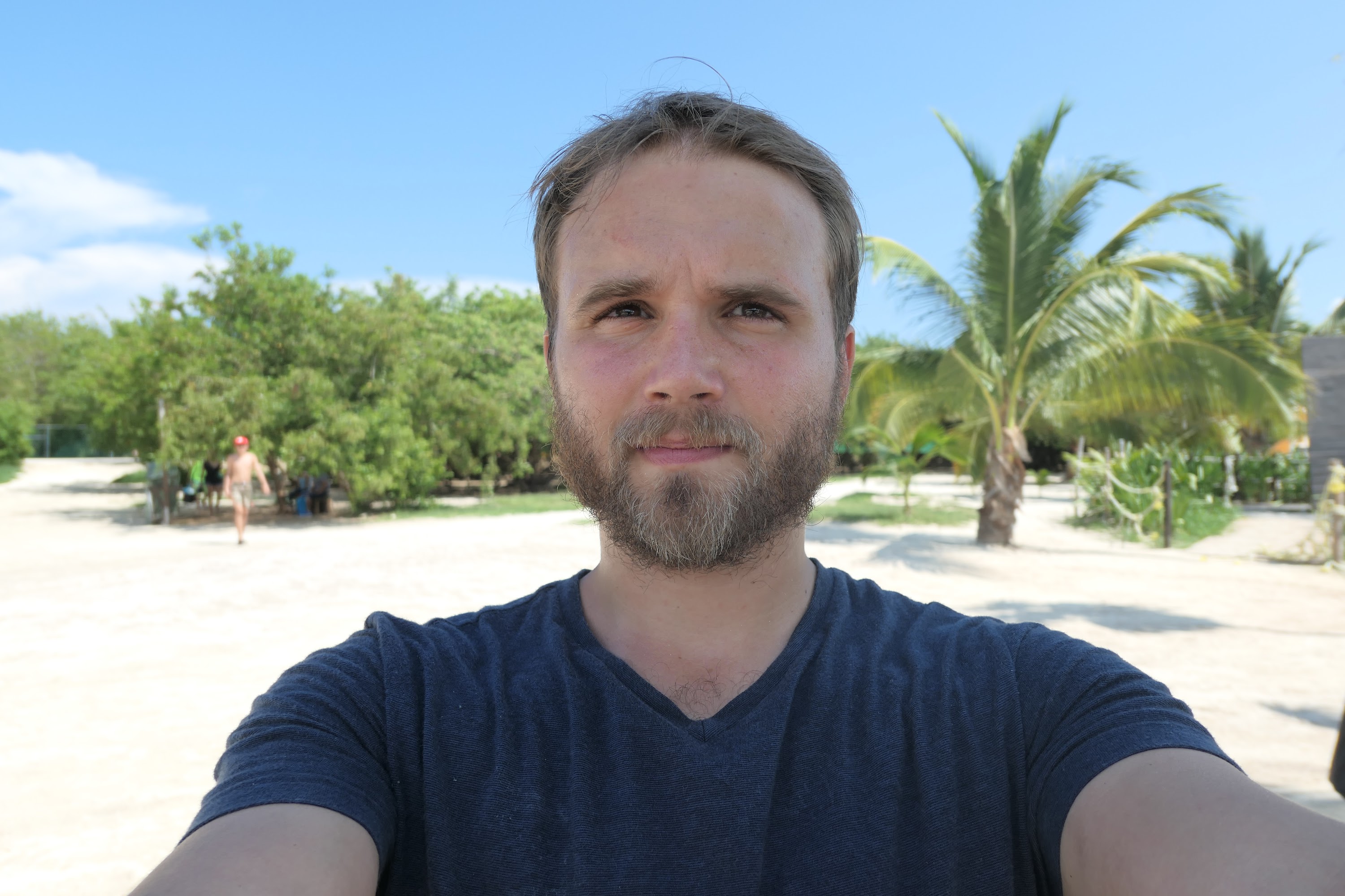 Bearded Man Taking Selfie on Beach