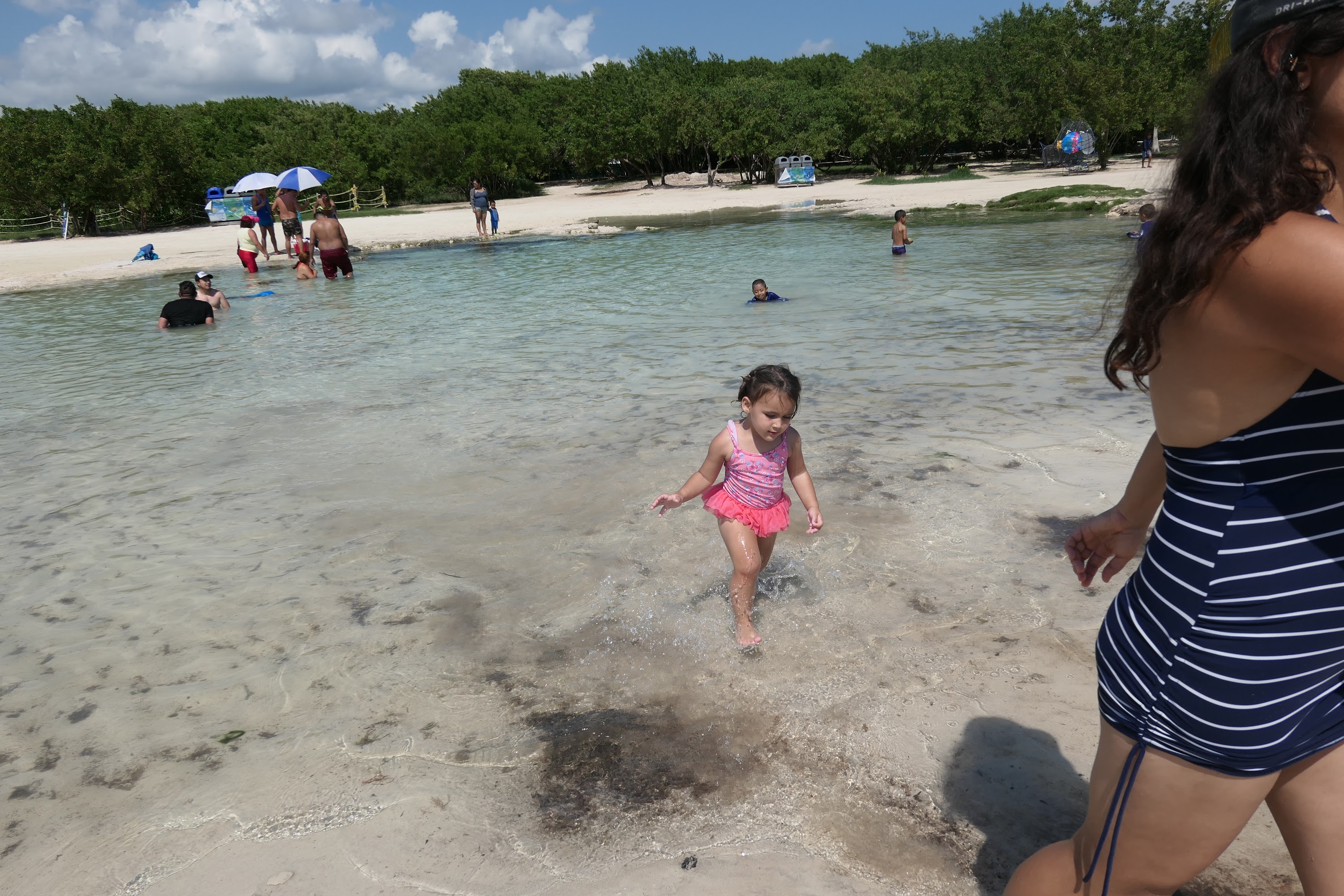 Young Girl Playing in Shallow Ocean Water at Beach