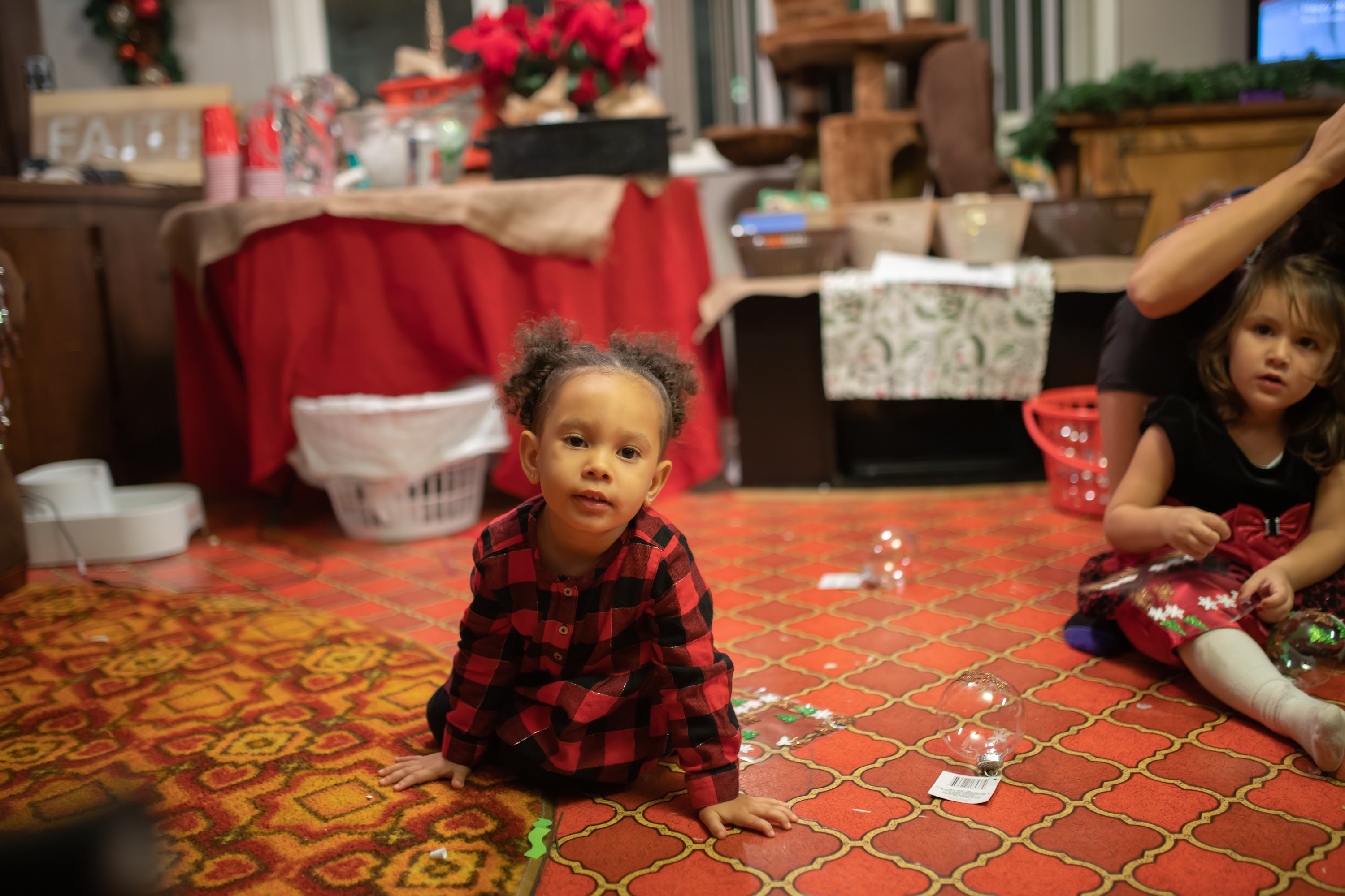 Two Young Girls Playing on a Holiday Floor