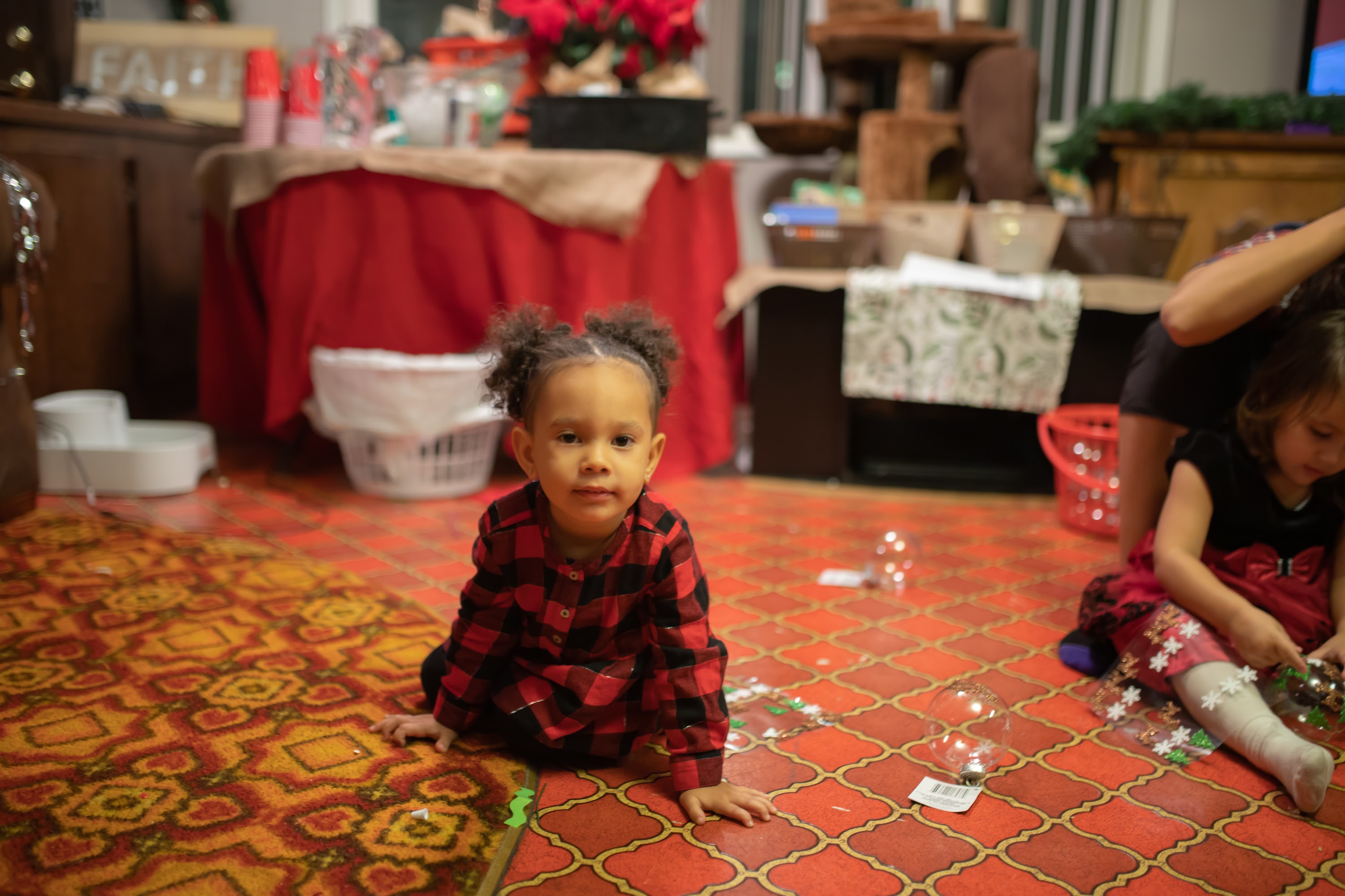 Young Girl in Red Plaid Dress on Patterned Floor