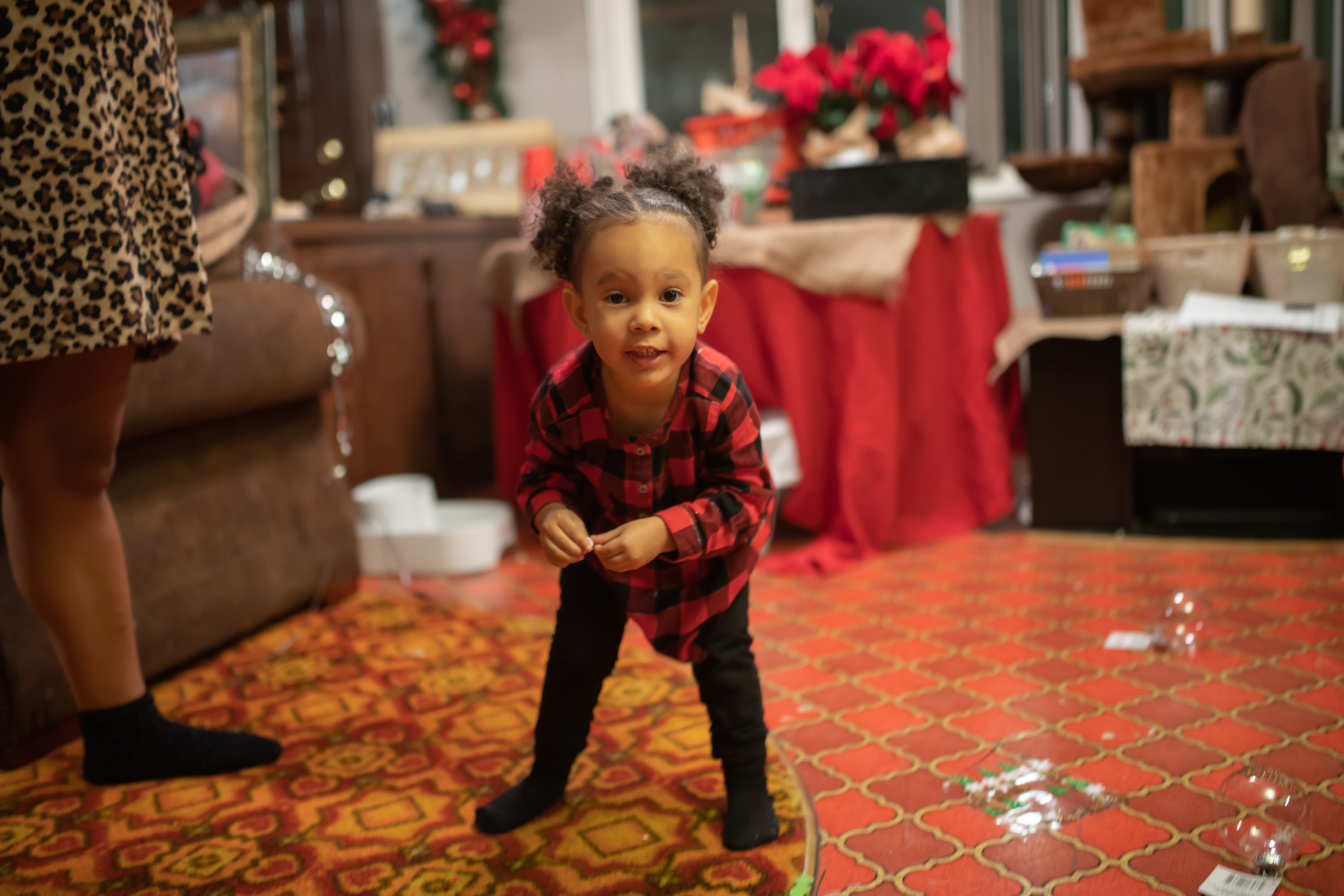 Young Girl in Plaid Shirt Playing with Bubbles at Home