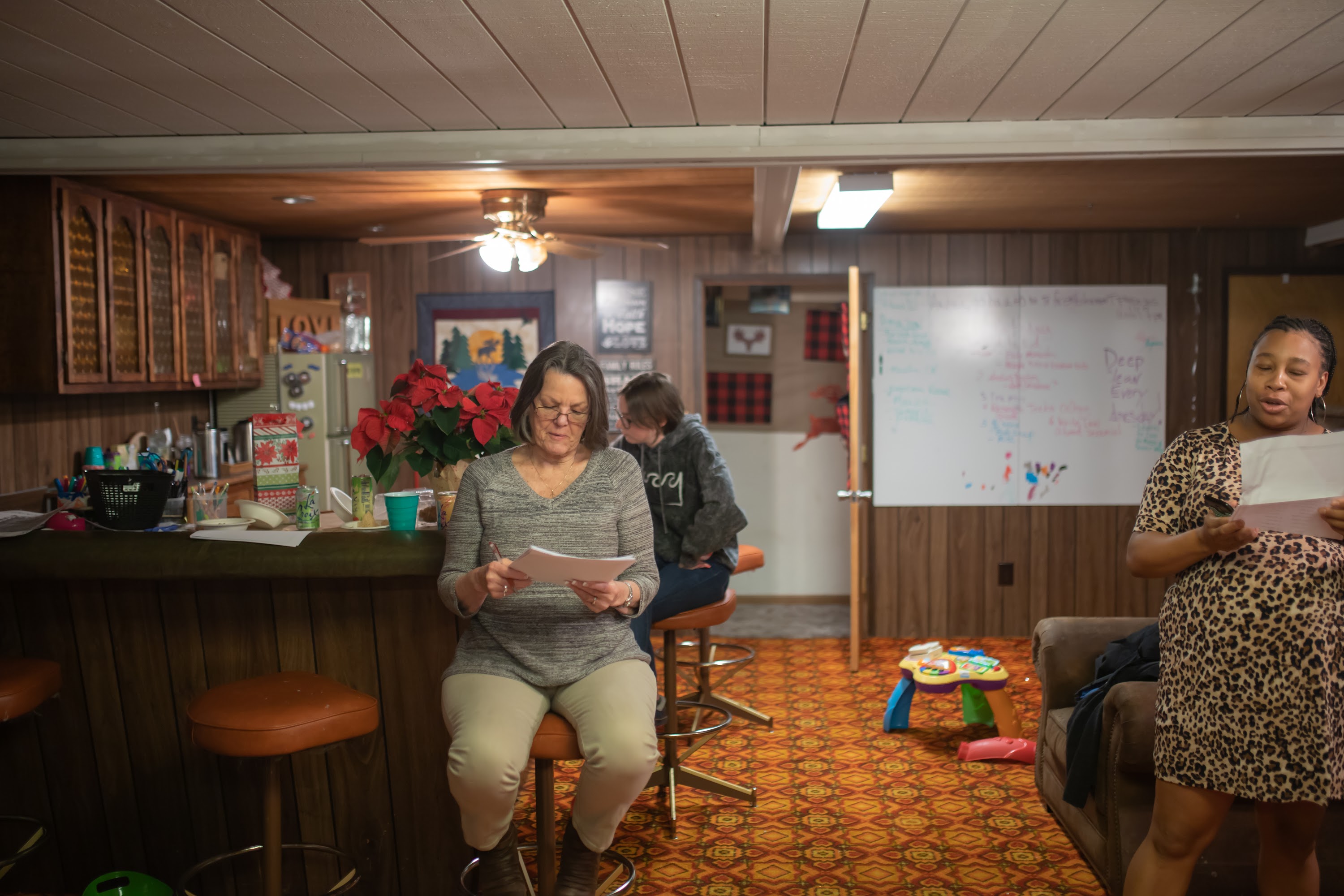 Women Reading Papers in a Cozy Basement Room
