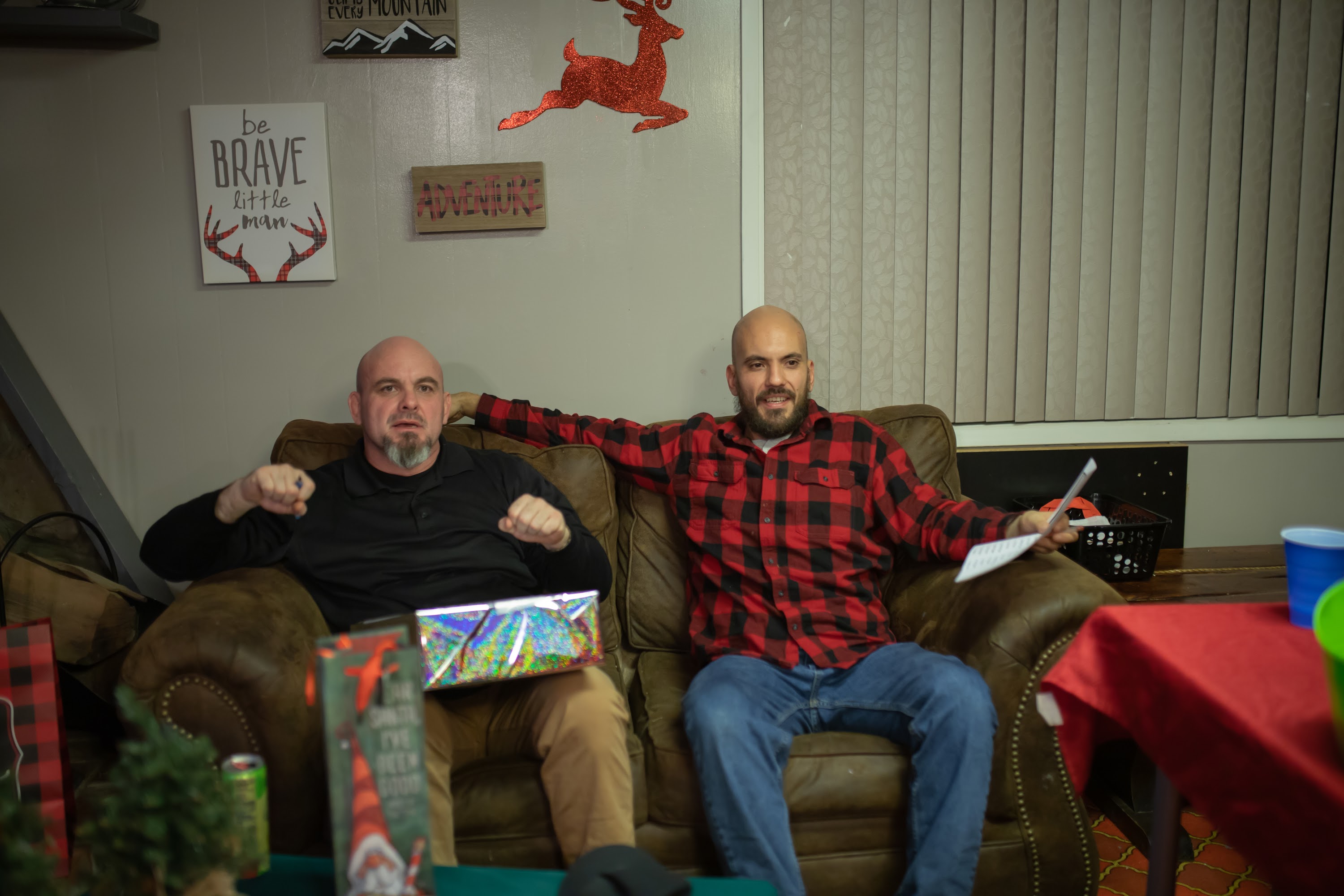 Two Men Relaxing on a Couch with Holiday Decor