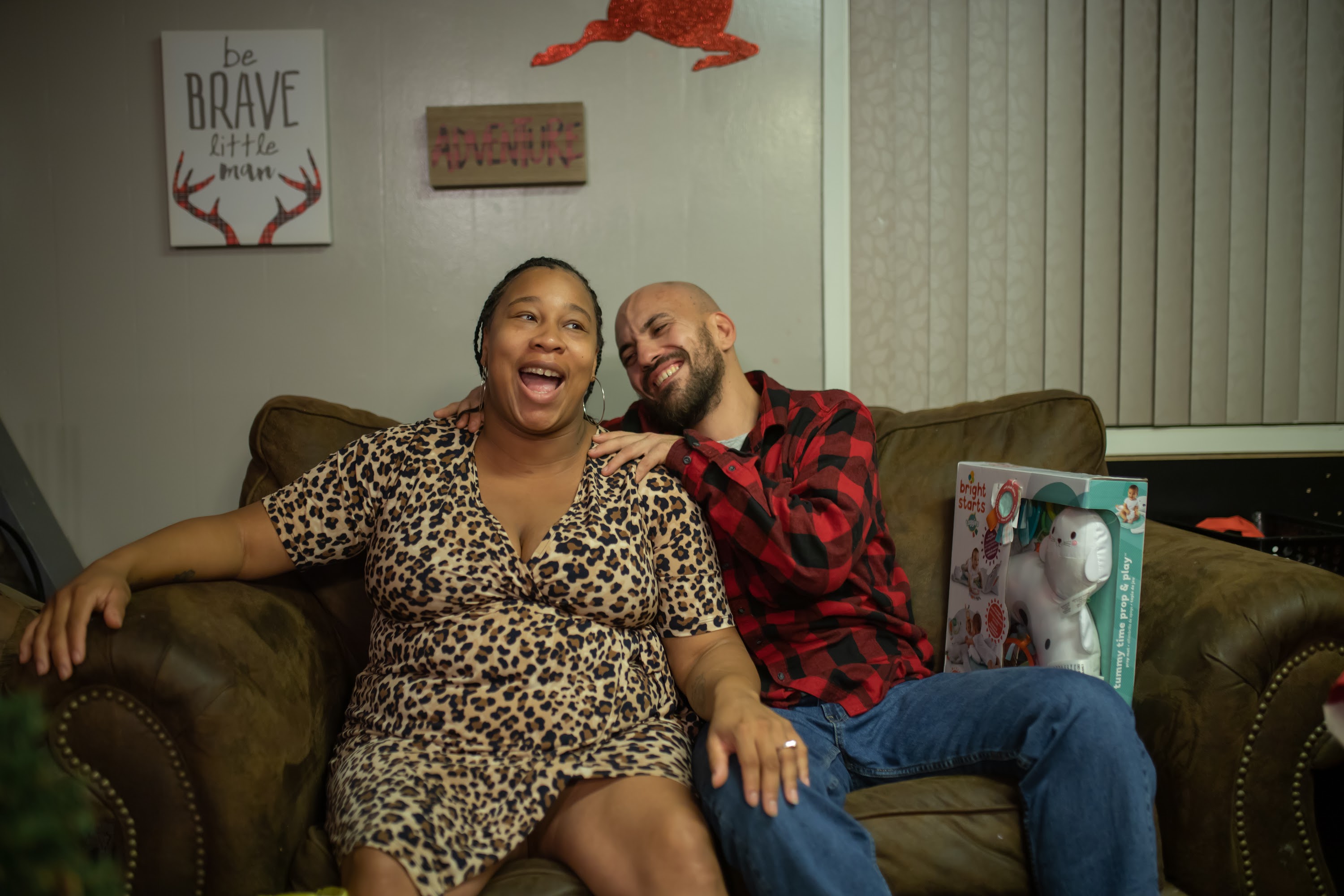 Happy Couple Laughing on Couch