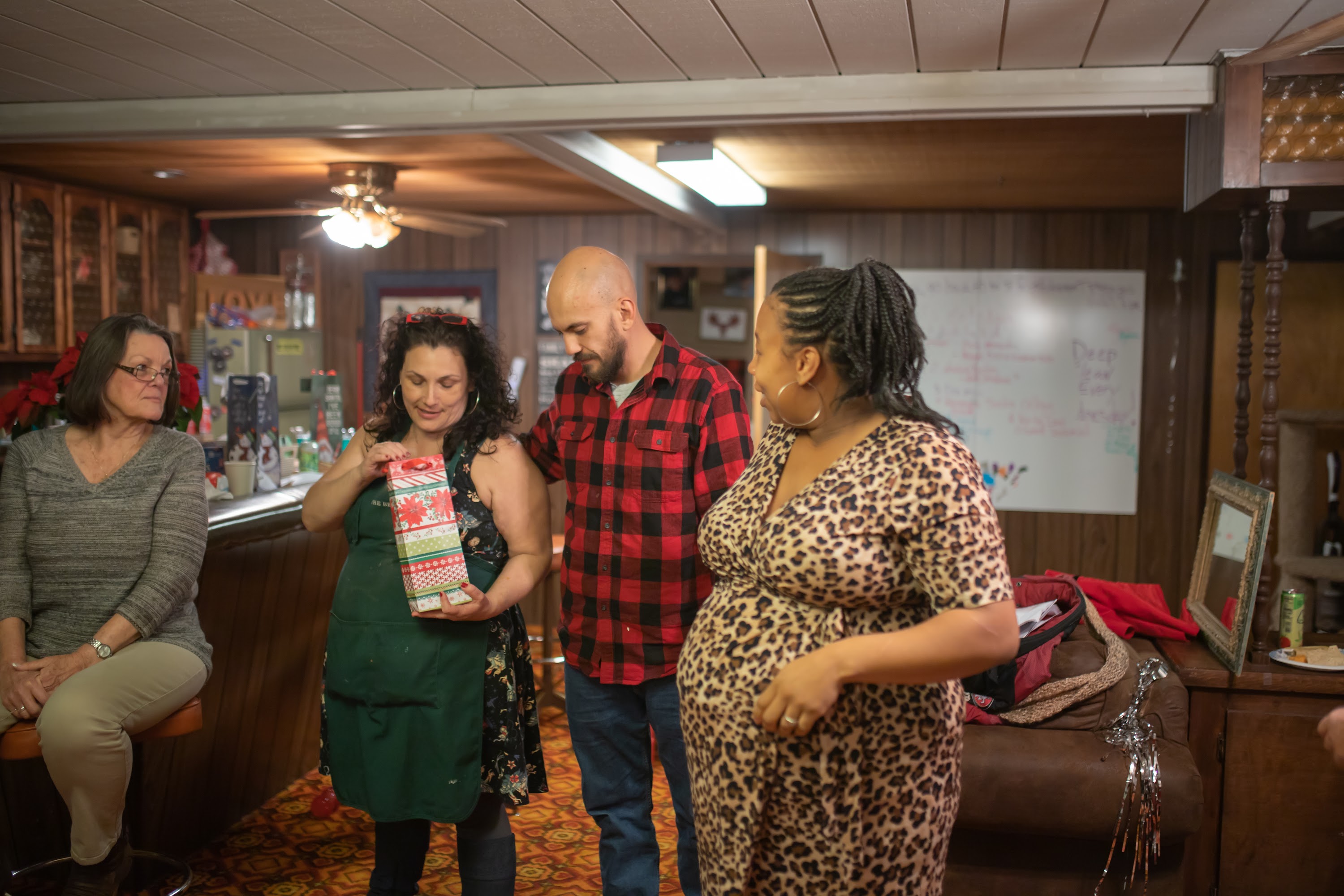 Family Gathering with Pregnant Woman and Gift Exchange